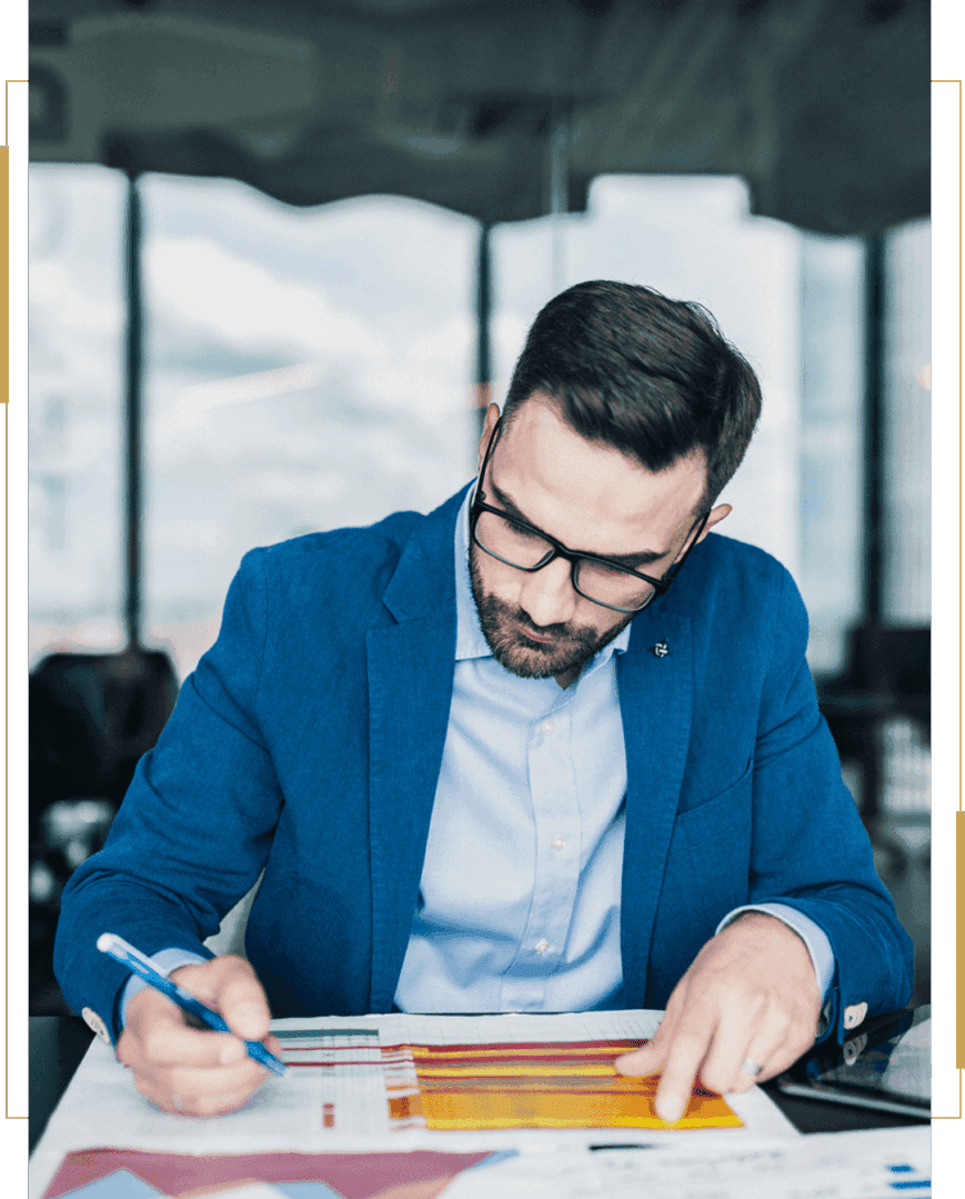 Man analyzing charts in a blue suit.